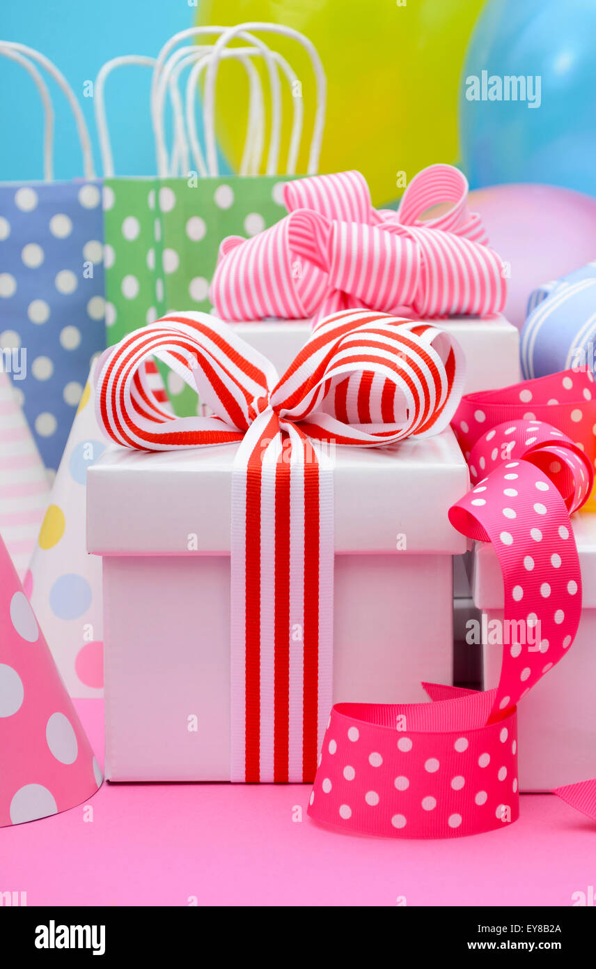 Bright colorful party table with balloons, streamers, party favor gift