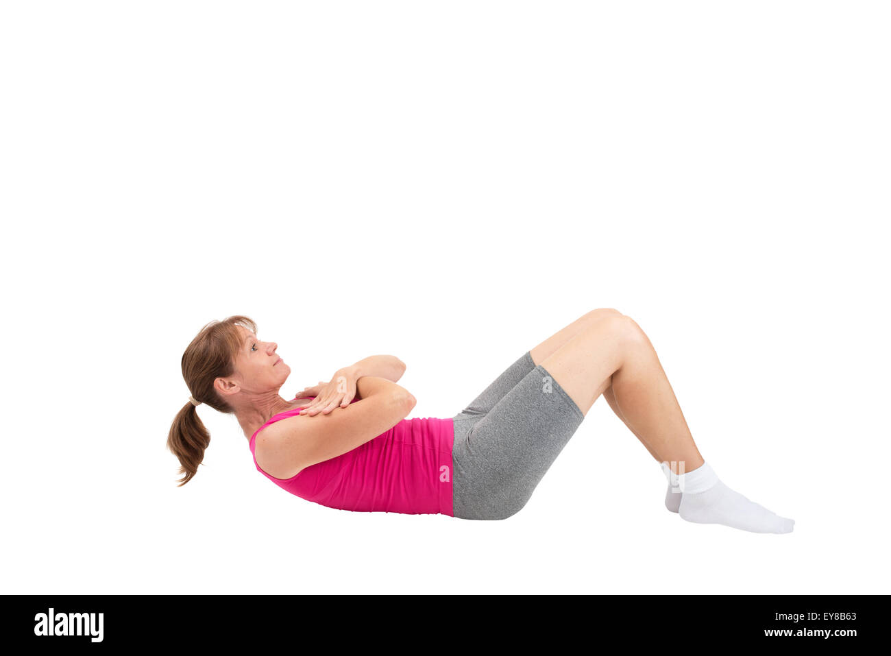 Sporty woman doing sit-ups Stock Photo