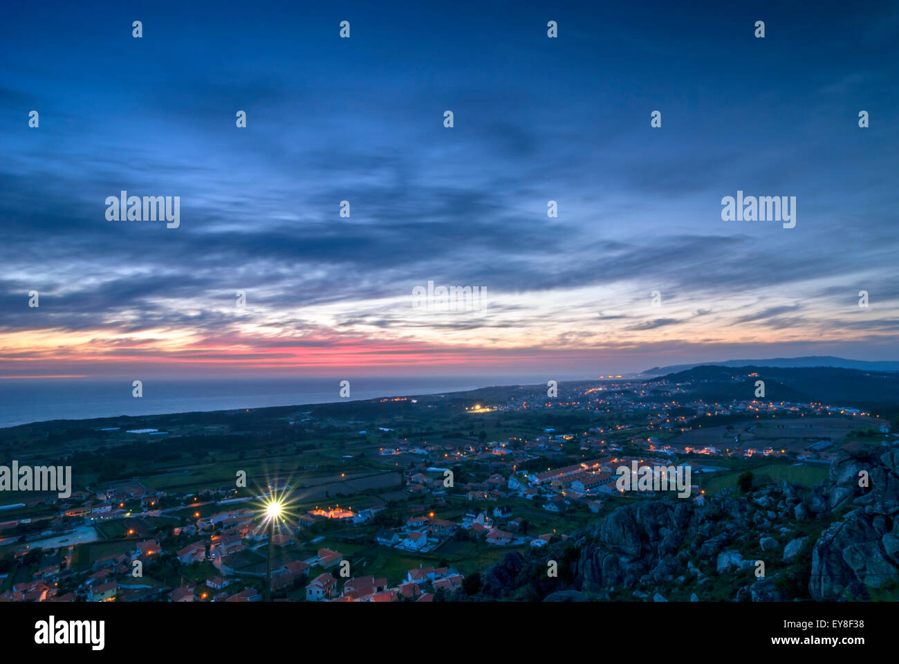 Scenic view over small town in Portugal, Atlantic Ocean and sunset sky in the evening Stock Photo