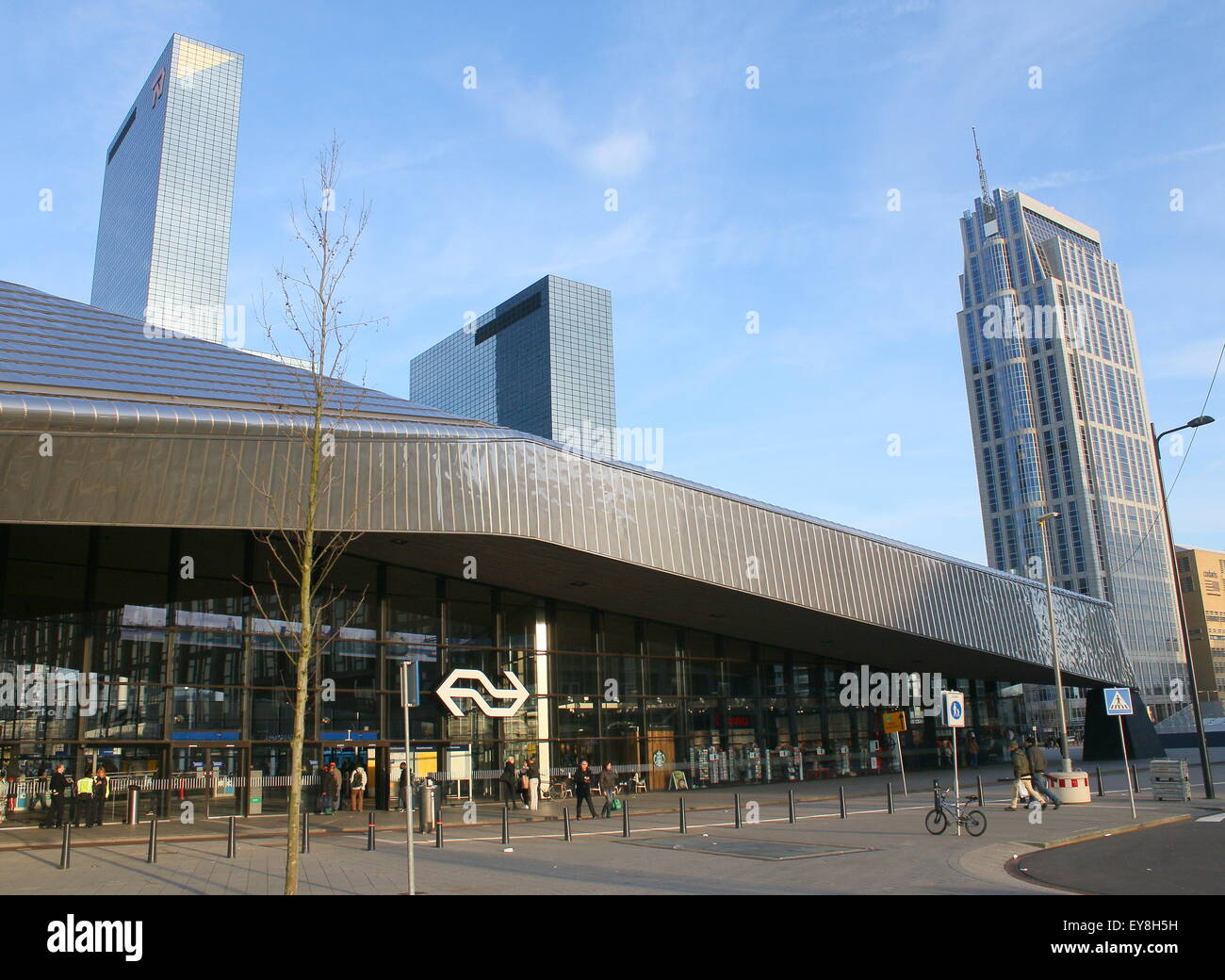 Side entrance to Rotterdam Centraal railway station, Rotterdam, The Netherlands. Highrise Manhattan Hotel in the background Stock Photo