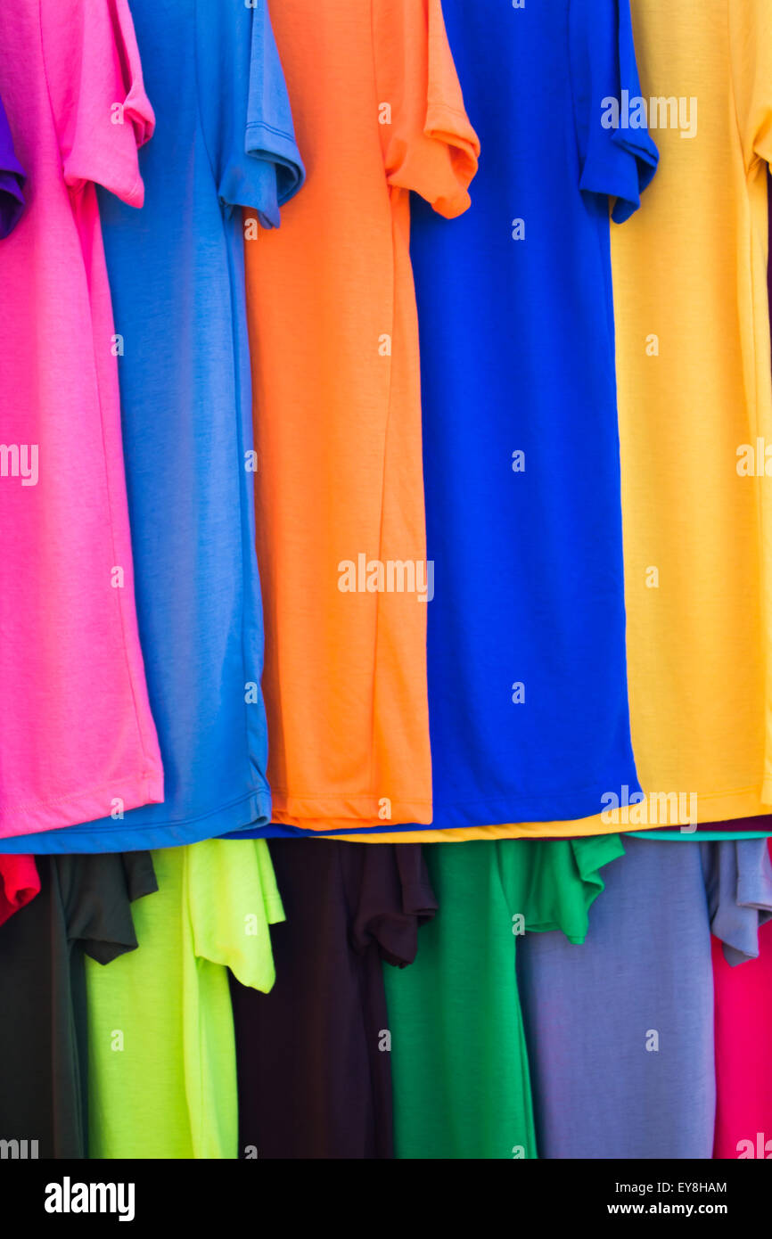 Lots of bright colorful clothing, abstract background. Stock Photo