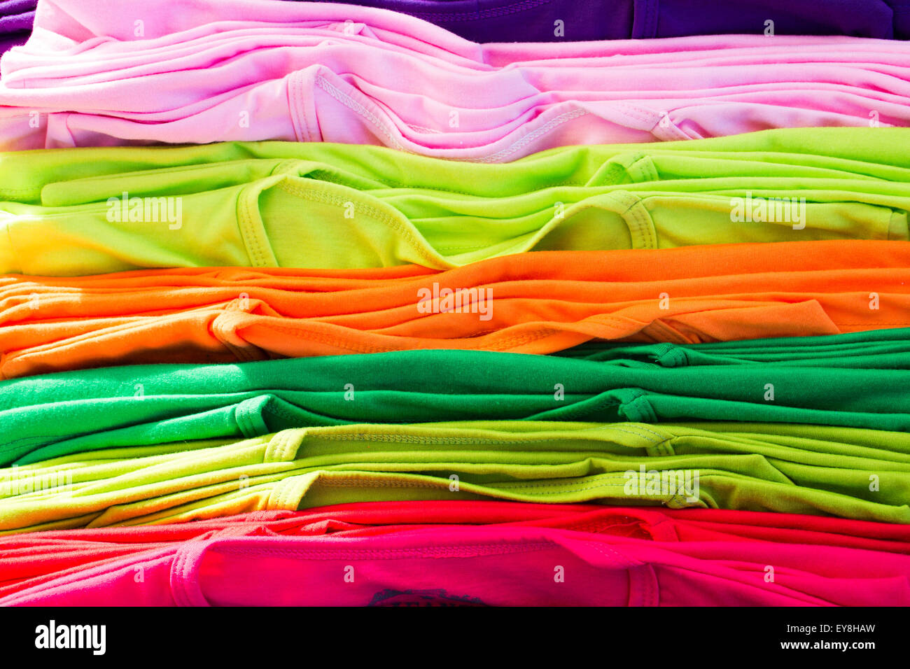 Lots of bright colorful clothing, abstract background. Stock Photo