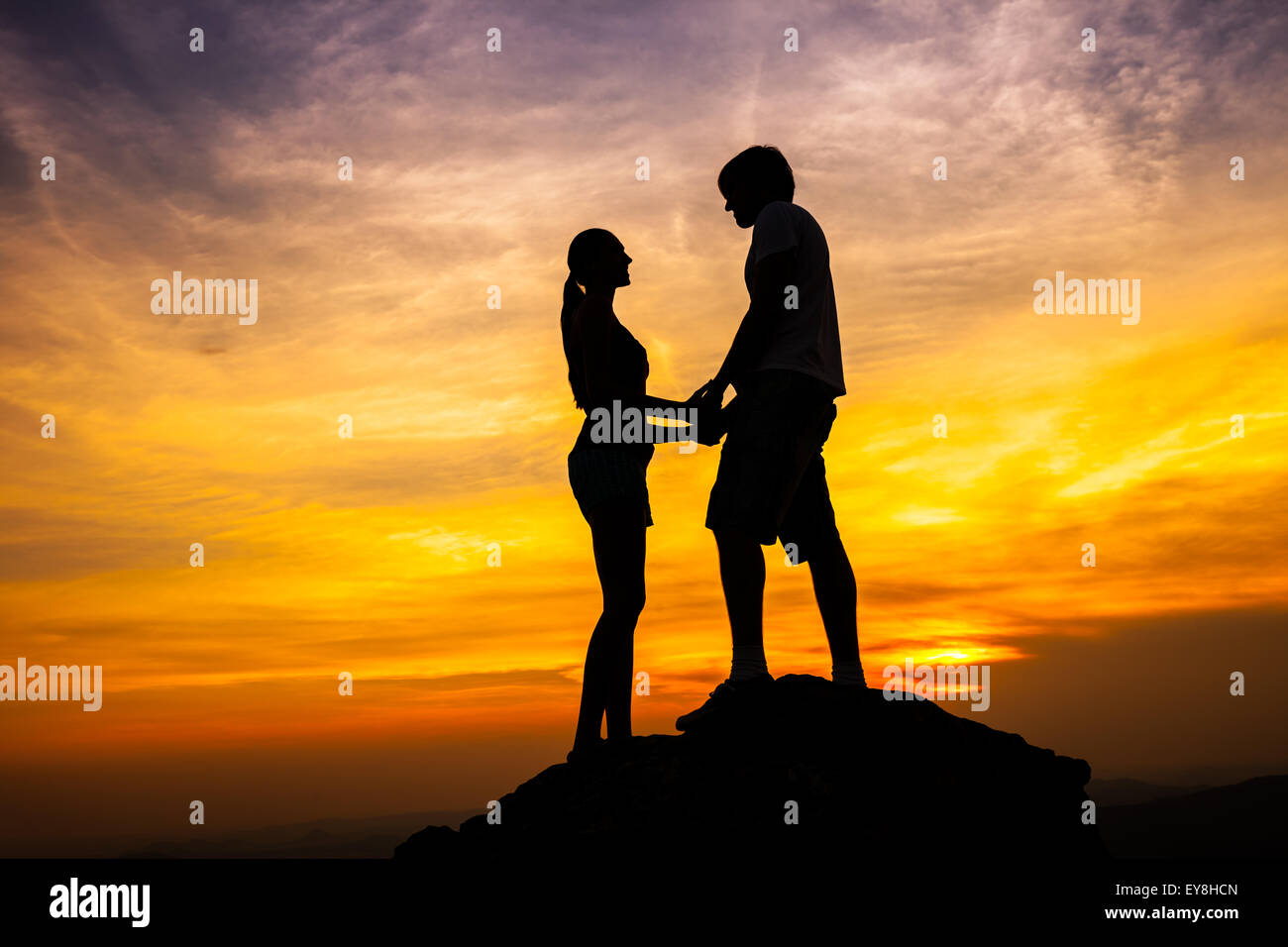 Silhouette of loving couple in sunset Stock Photo - Alamy