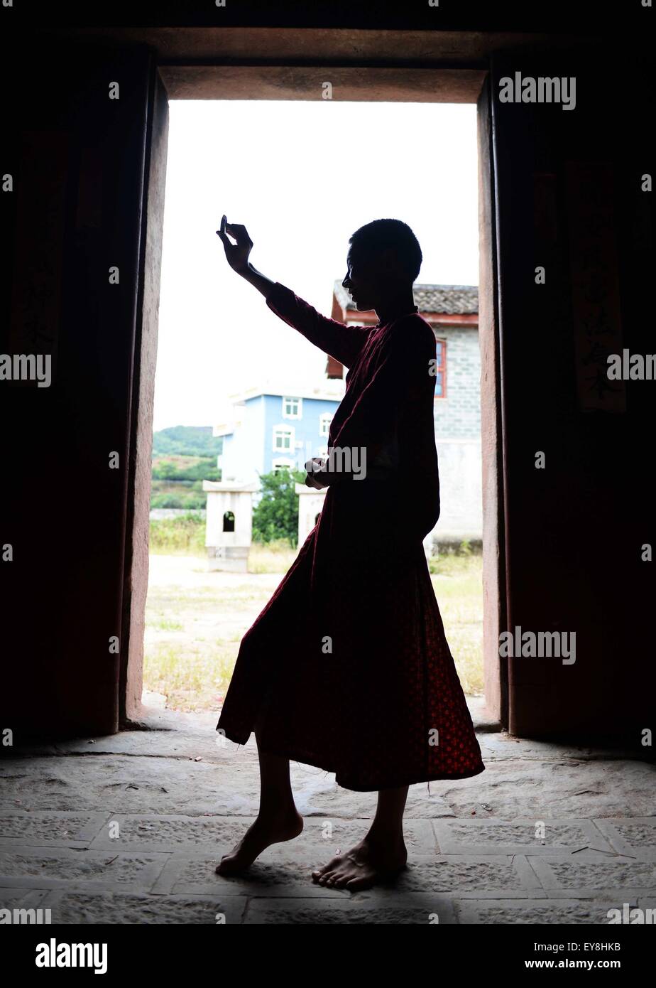 Nanfeng, China's Jiangxi Province. 23rd July, 2015. Fifteen-year-old boy Wu Peng, the oldest in class, practises playing drunken god in Nuo dance in Shiyou Village, Sanxi Township of Nanfeng County, east China's Jiangxi Province, July 23, 2015. Nuo dance used to be sacrificial rituals in ancient China to expel evil spirits and pray for good harvests. Ye Genming, an inheritor of Nuo dance, set up this teenager training classes to carry on 'the living fossil of ancient dance' about a decade ago. © Chen Zixia/Xinhua/Alamy Live News Stock Photo