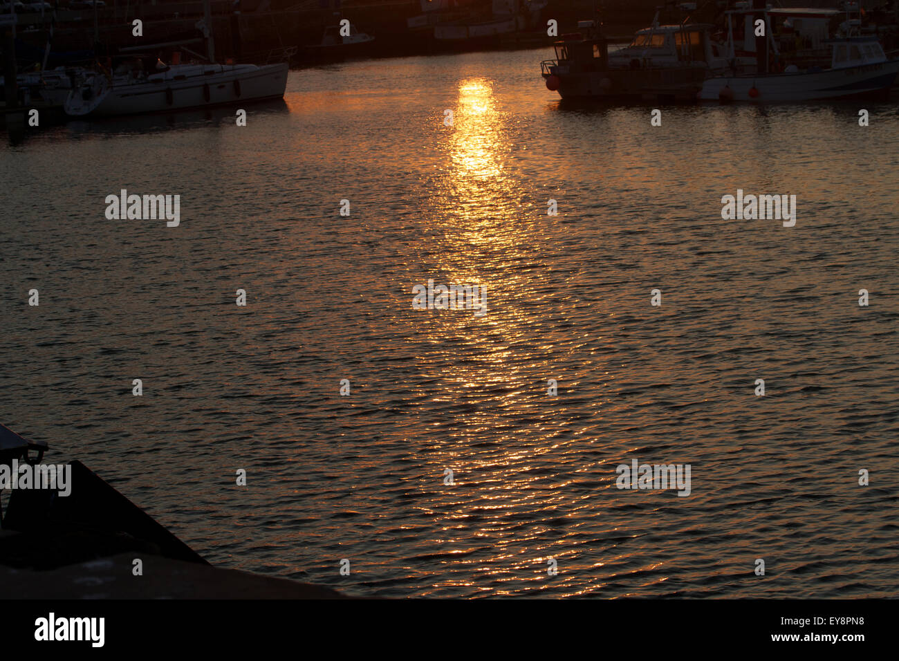 Sunset over water Stock Photo - Alamy
