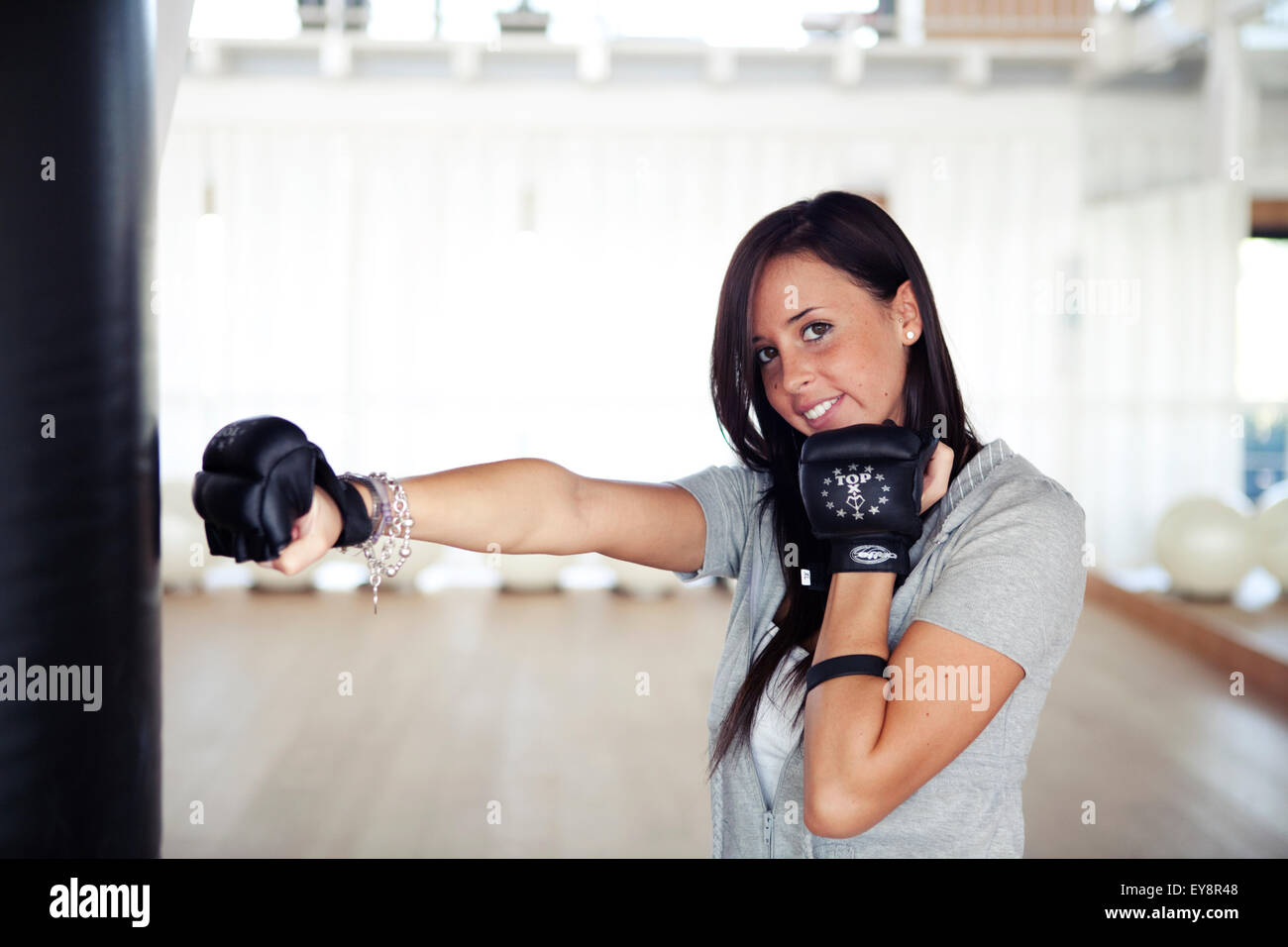 Young girl in her 20s training with boxing gloves Stock Photo