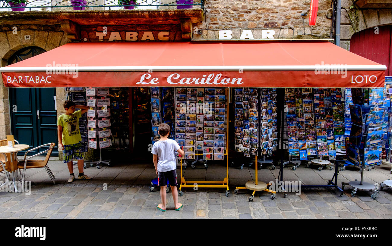 Browsing a postcard shop in Dinan, Brittany, France Stock Photo