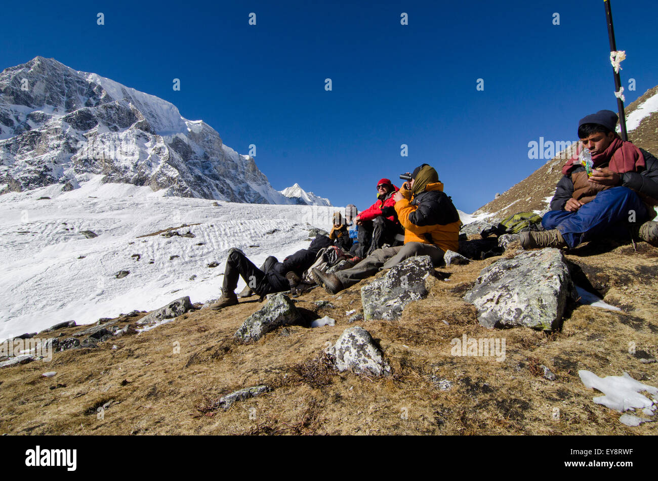 Trekkers rest on the Larke La Pass of the Manaslu Circuit trek in Nepal Stock Photo