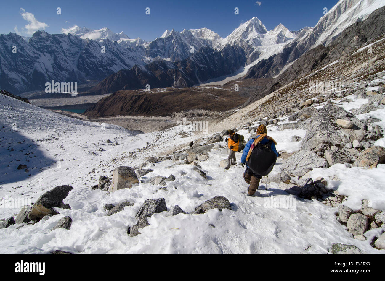 Trekkers on the Larke La Pass of the Manaslu Circuit trek looking west with views of the Annarpurna Range in Nepal Stock Photo