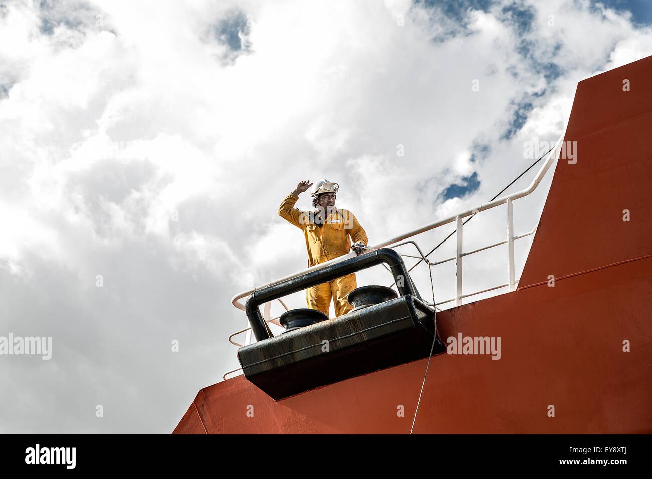 Worker mooring oil tanker on deck making hand gesture Stock Photo