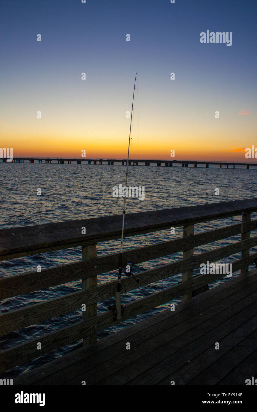 A fishing pole on a Lake Pontchartrain at Sunset. The Lake