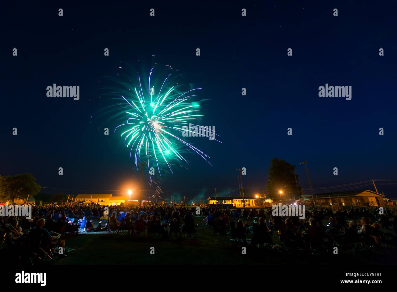 Crowd watching large firework display hires stock photography and