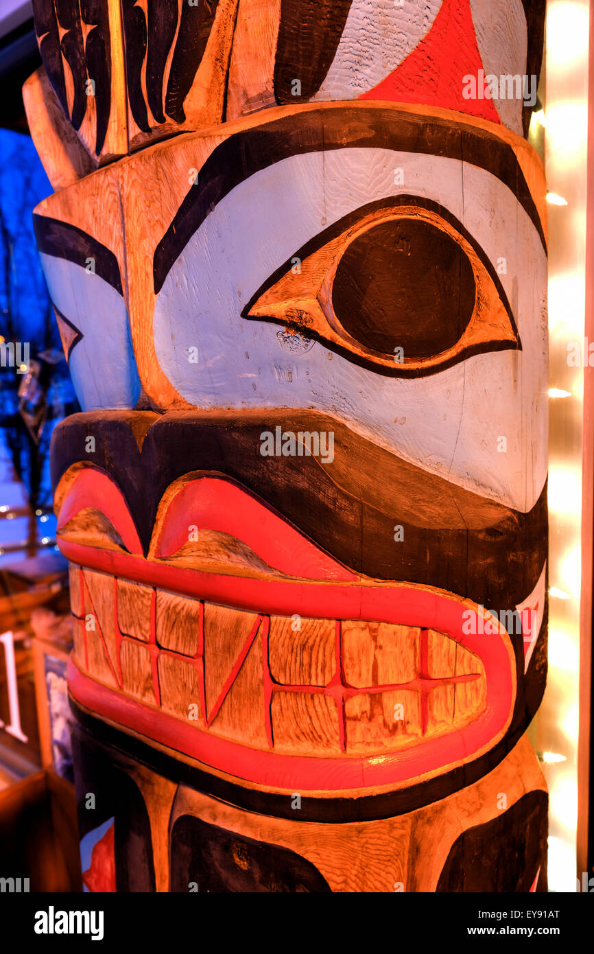 Close up of a totem pole with Christmas lights; Anchorage, Alaska ...