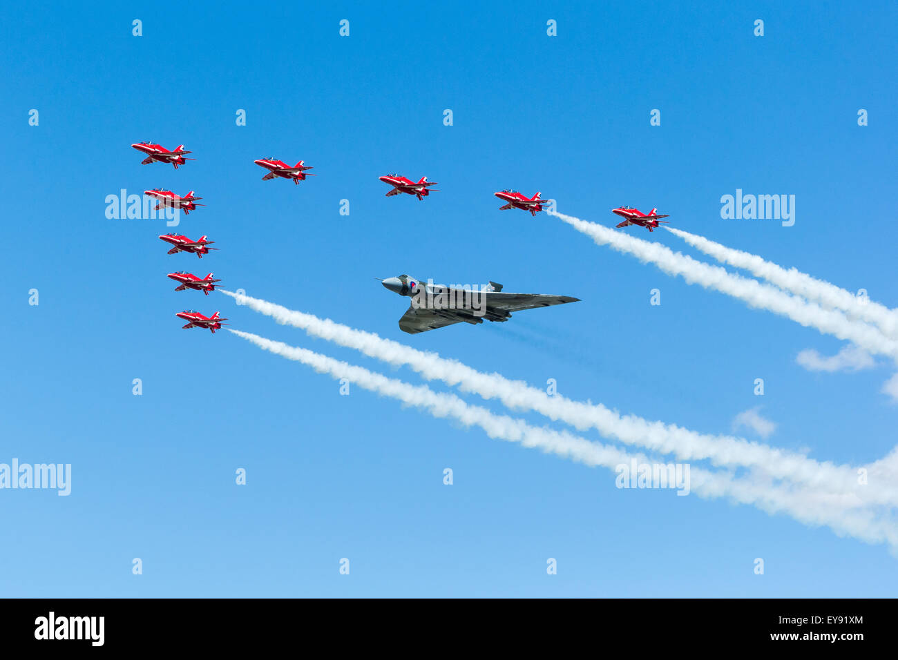 Avro 698 Vulcan B.2 XH558 takes part in its final RIAT fly past accompanied by the RAF Red Arrows with smoke on. Stock Photo