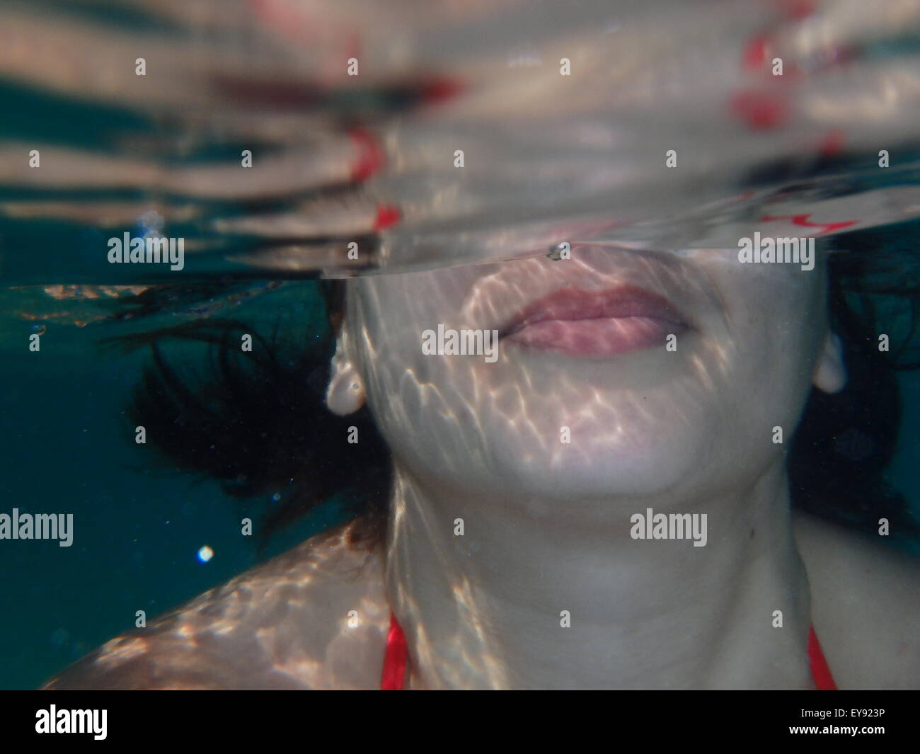 Woman diving under the surface of the sea without any equipment