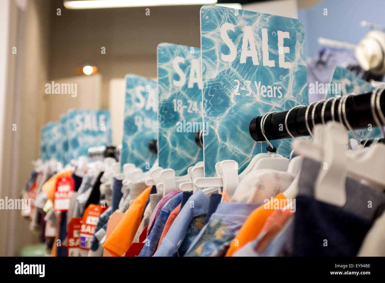 A rail of clothing in the sale at a british shop Stock Photo