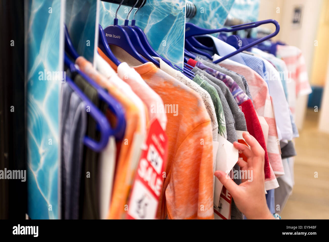 A rail of clothing in the sale at a british shop Stock Photo