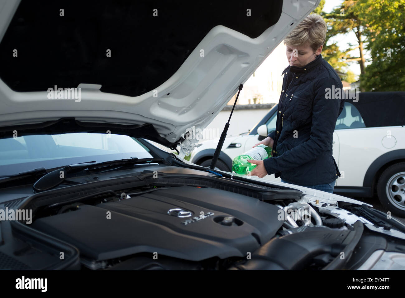 Wiper de icer re filling maintenance female lady lone woman driver hi