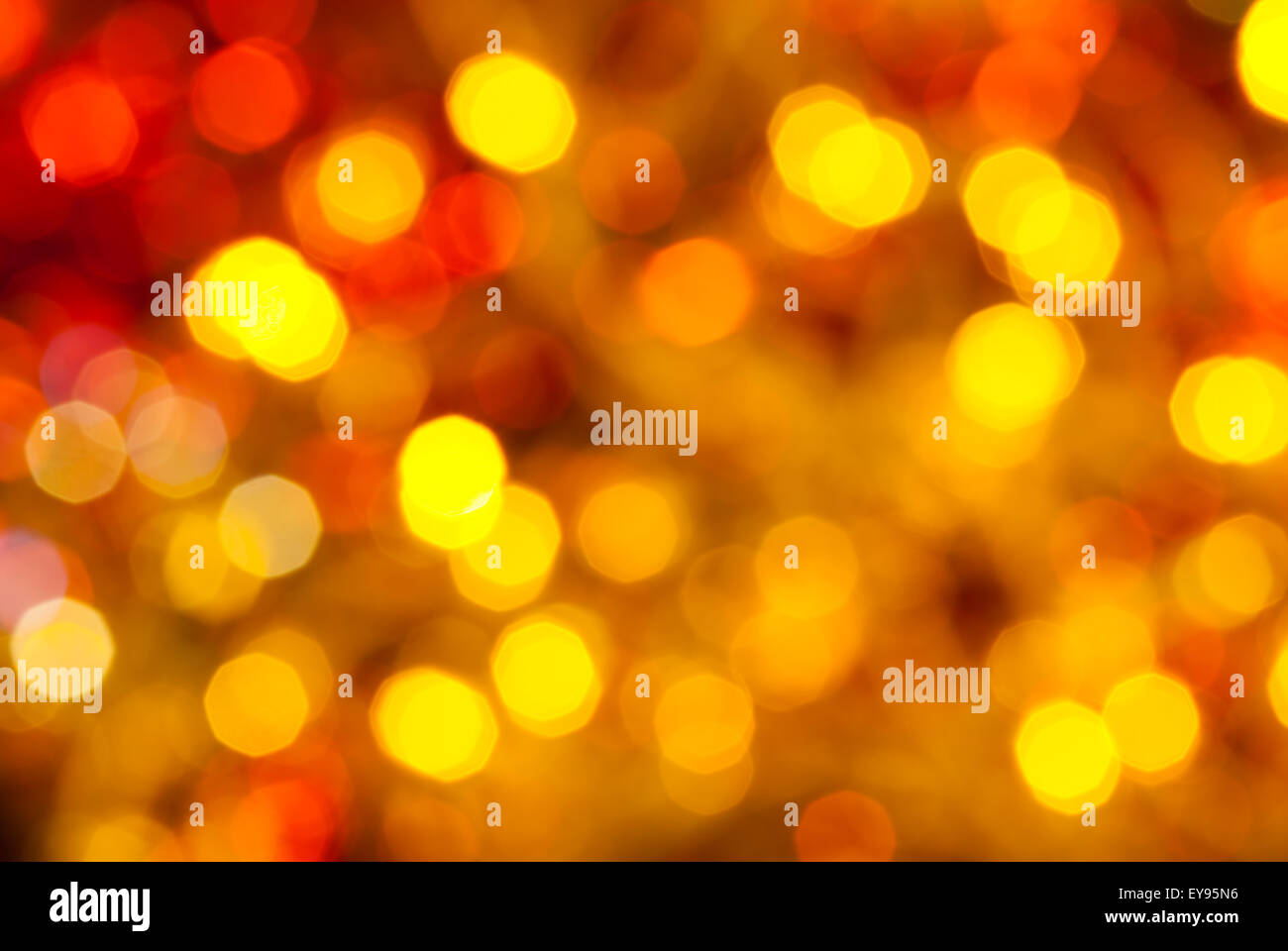 abstract blurred background - brown, yellow and red twinkling Christmas lights of electric garlands on Xmas tree Stock Photo