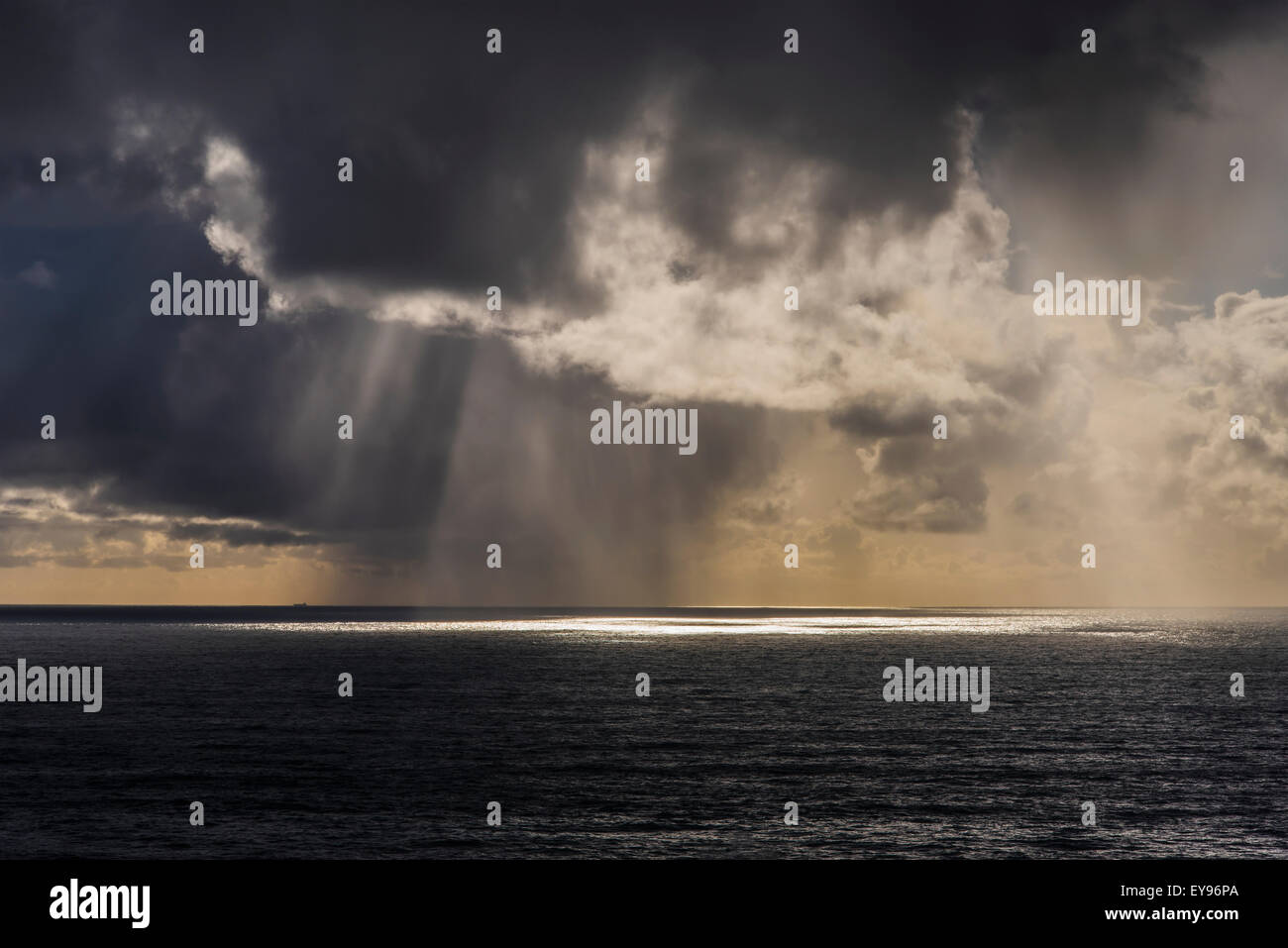 Rain falls in the distance off the coast; Oregon, United States of ...