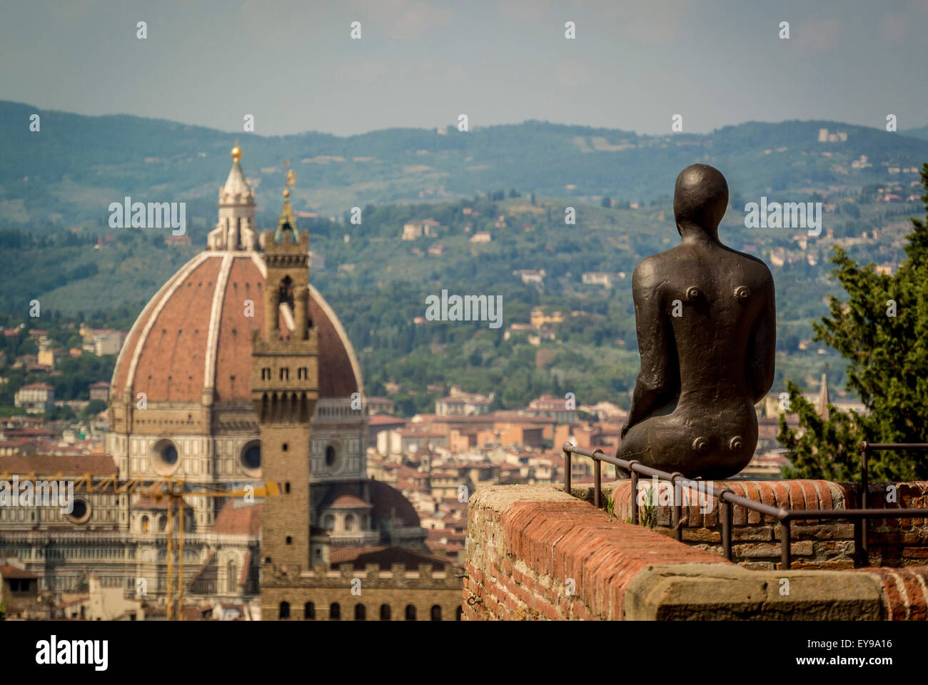 Florence Cathedral with Antony Gormley's iron man sculpture in the foreground. Shot from Fort Belvedere. Part of the HUMAN exhibition. Florence, Italy. Stock Photo