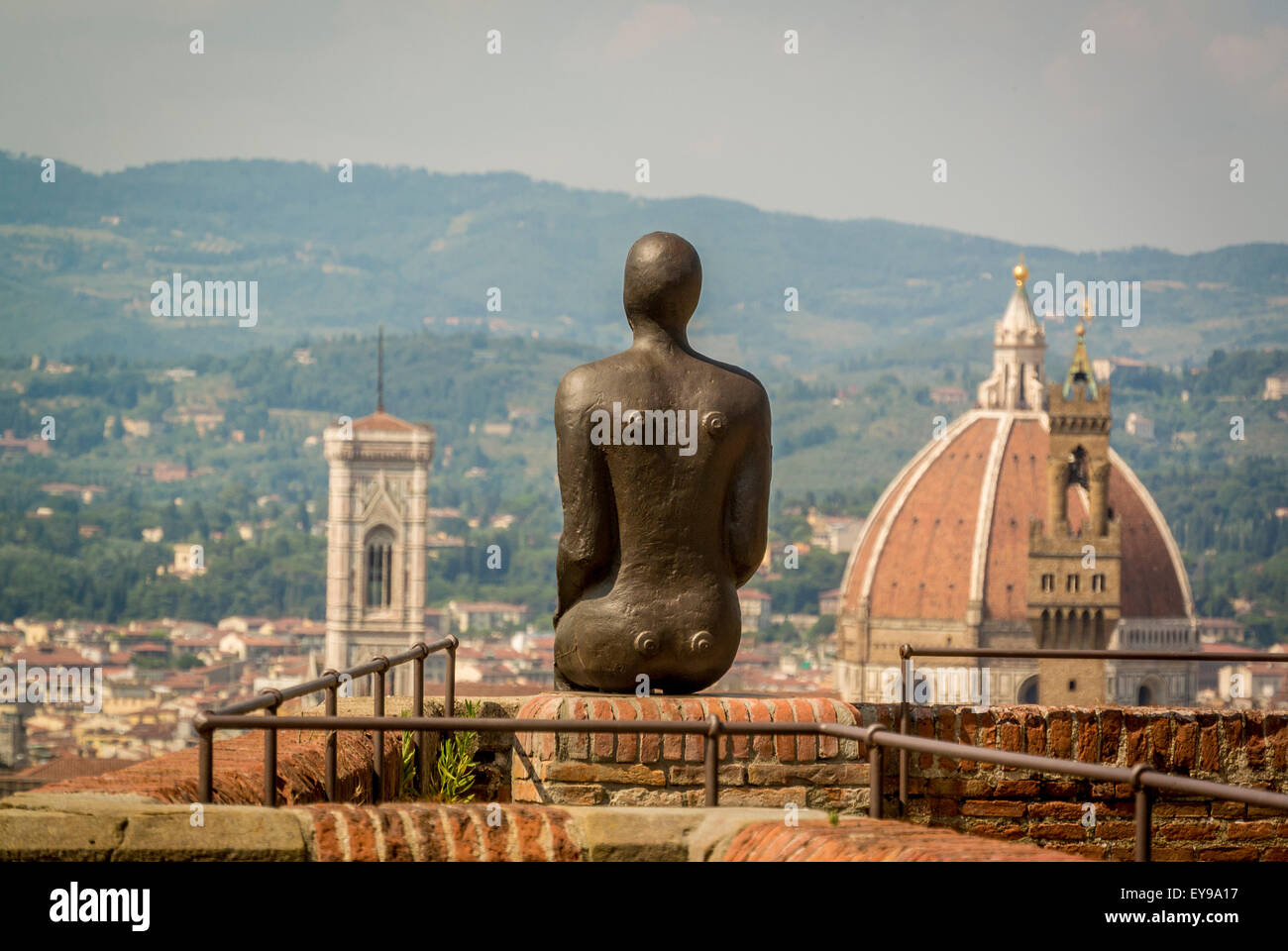 Florence Cathedral with Antony Gormley's iron man sculpture in the foreground. Shot from Fort Belvedere, Florence. Part of the HUMAN exhibition. Stock Photo