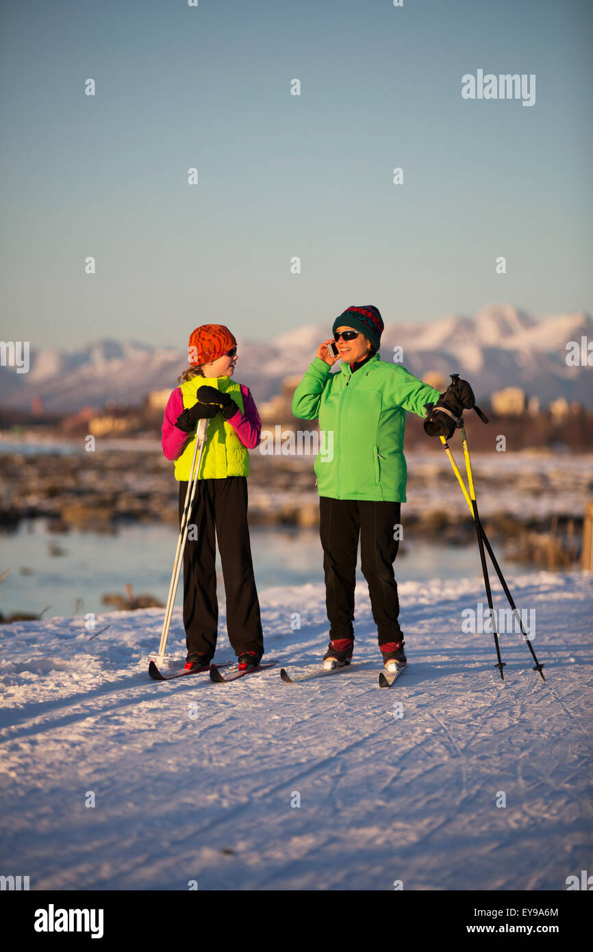 Two people cross country skiing on the Tony Knowles Coastal Trail with