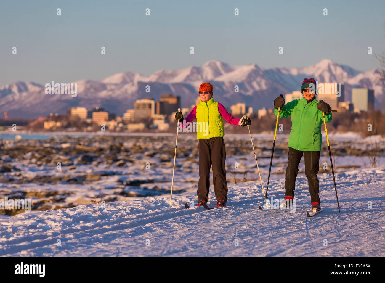 Two people cross country skiing on the Tony Knowles Coastal Trail with