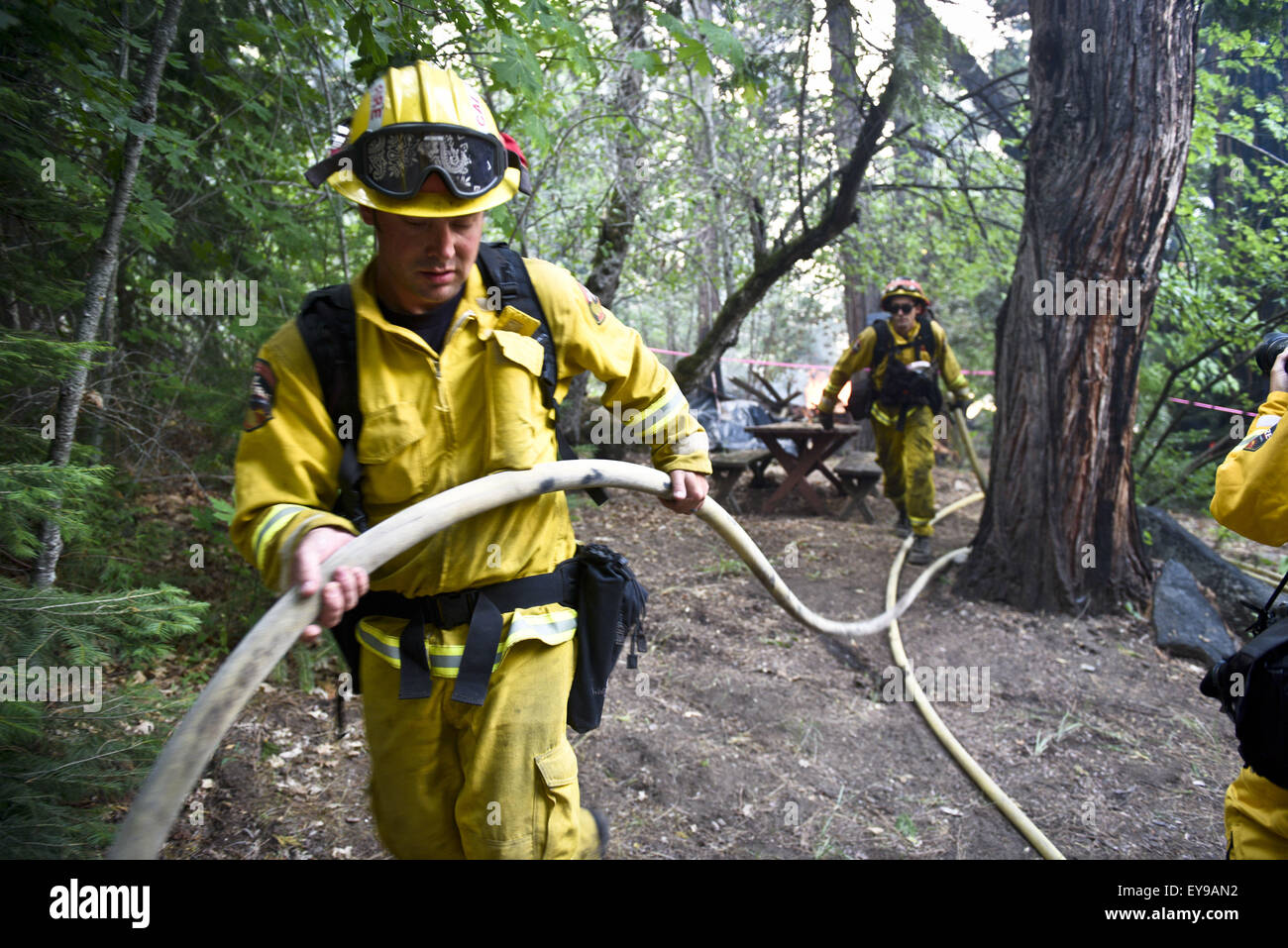 Vacaville And Placerville, CA, USA. 23rd July, 2015. CAL FIRE firefighters  help to defend a structure off of US 50 at the 100-acre Kyburz Fire in the  El Dorado National Forest Thursday