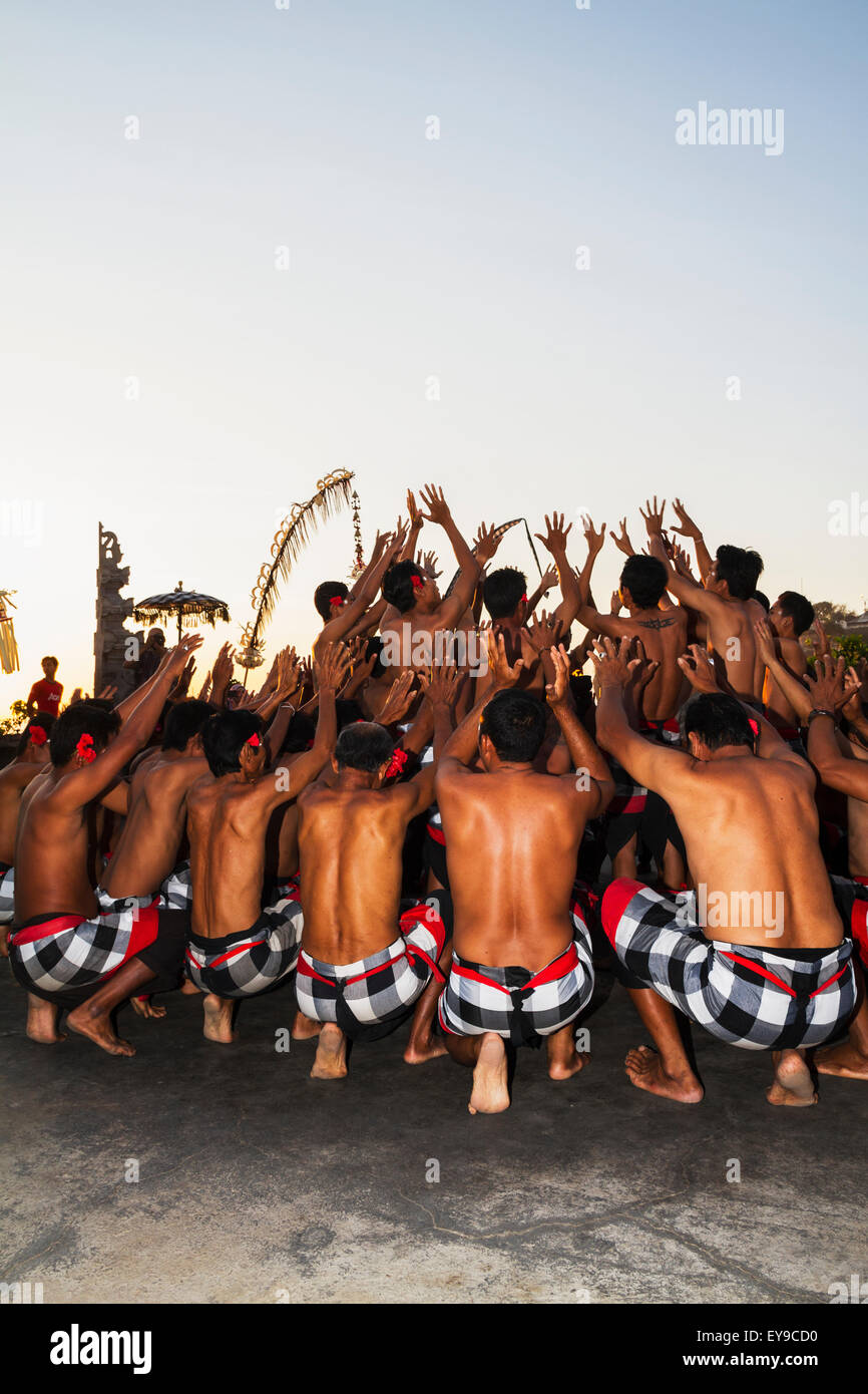 Men dancing in a circle chanting in trance during a Kecak dance performance, Ulu Watu, Bali, Indonesia Stock Photo