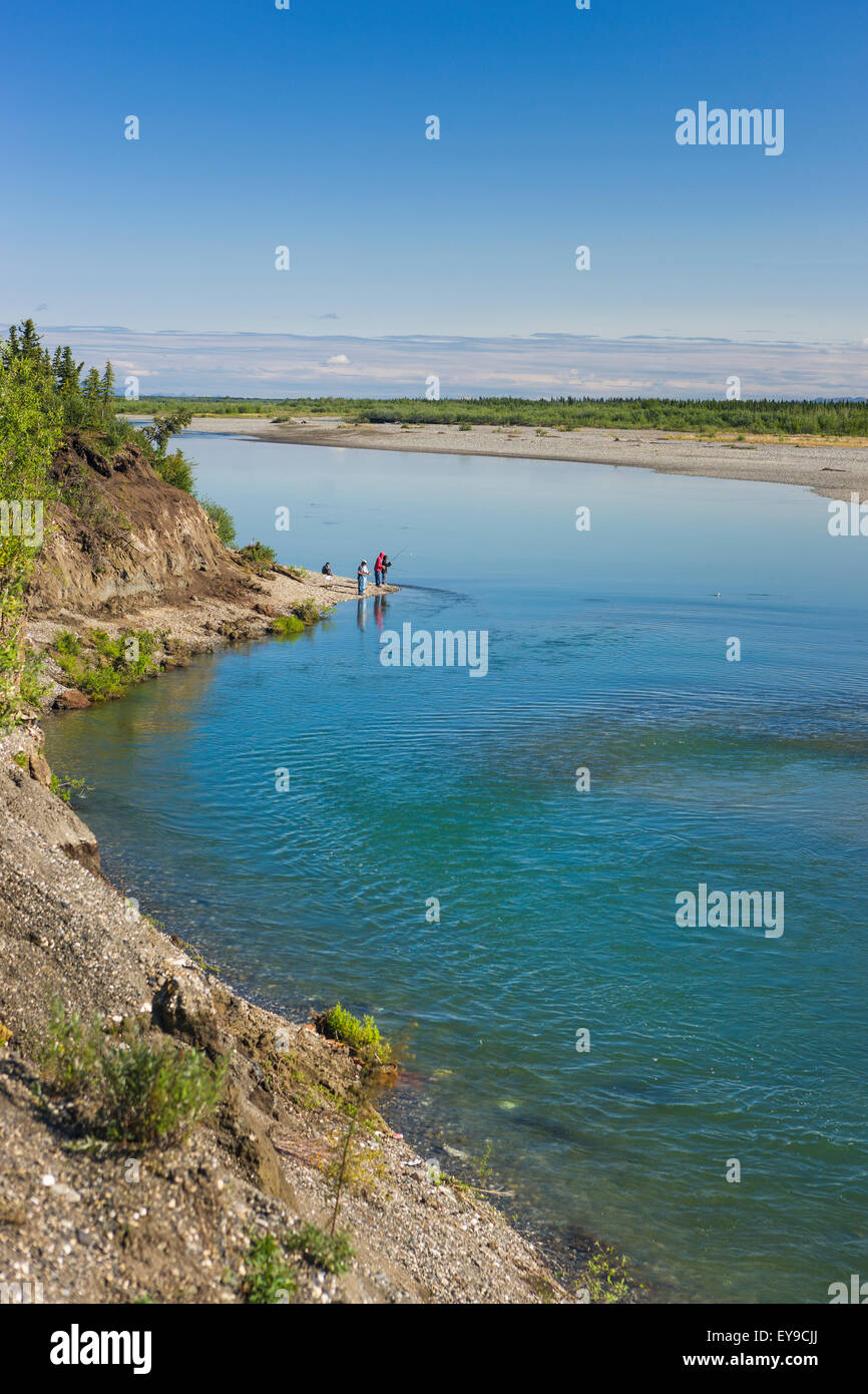Children from Noatak Village fishing with fishing poles on the banks of