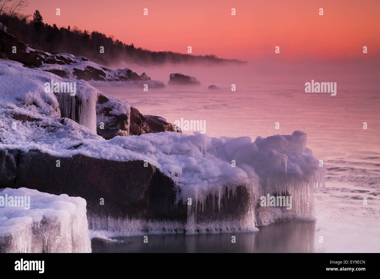 Frozen rocks along the North Shore of Lake Superior at sunrise; Duluth, Minnesota, United States of America Stock Photo