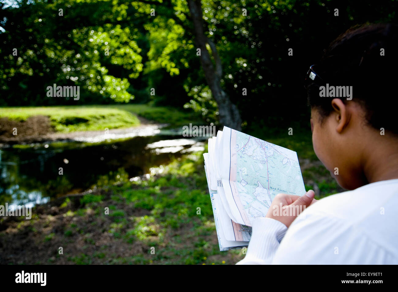 woman-looking-at-map-in-forest-stock-photo-alamy