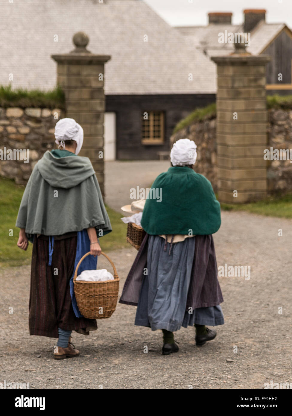 Women in period costume walking at Fortress Louisbourg, Louisbourg, Nova Scotia, Canada - Stock Image
