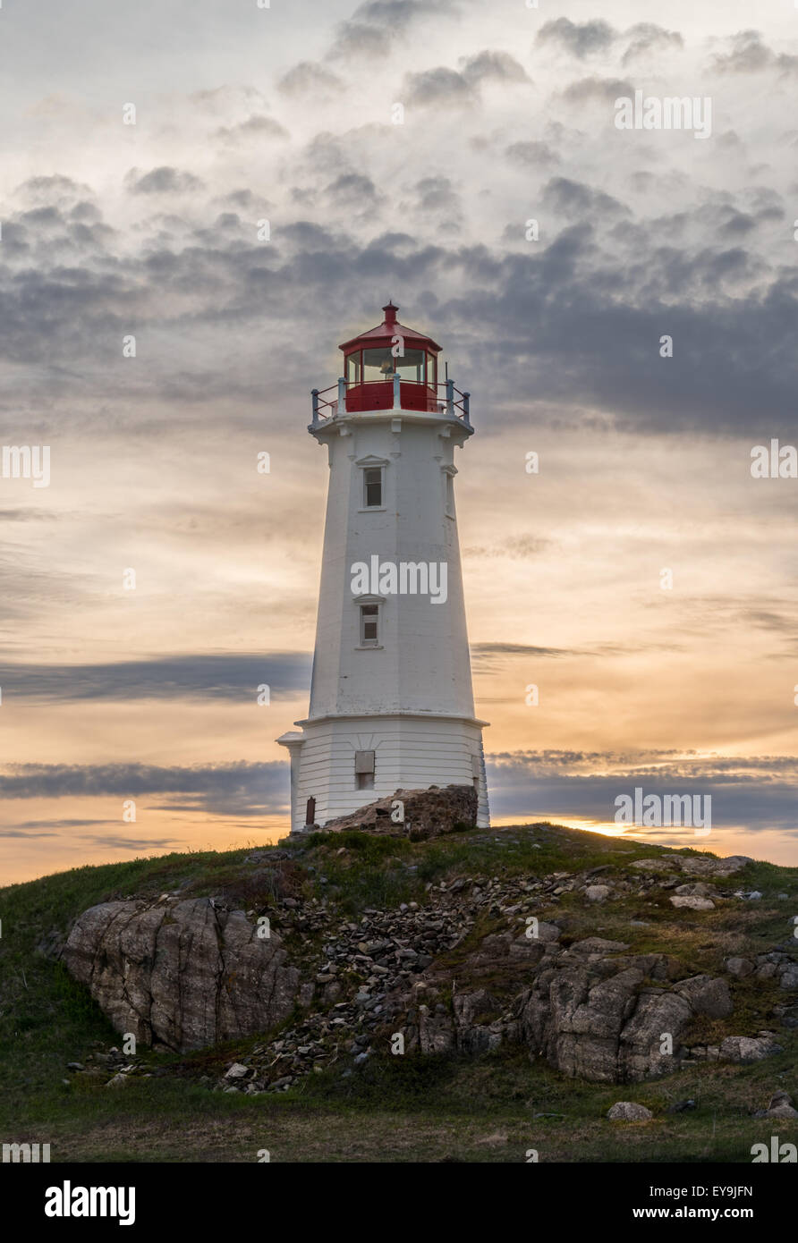 Louisbourg lighthouse at sunset, Louisbourg, Nova Scotia, Canada - Stock Image