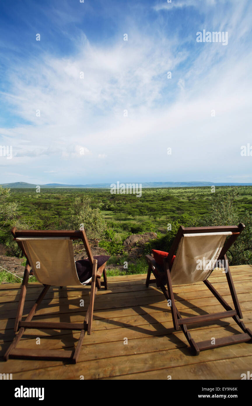 Two Deck Chairs On Wooden Deck Overlooking Grassland Stock Photo - Alamy