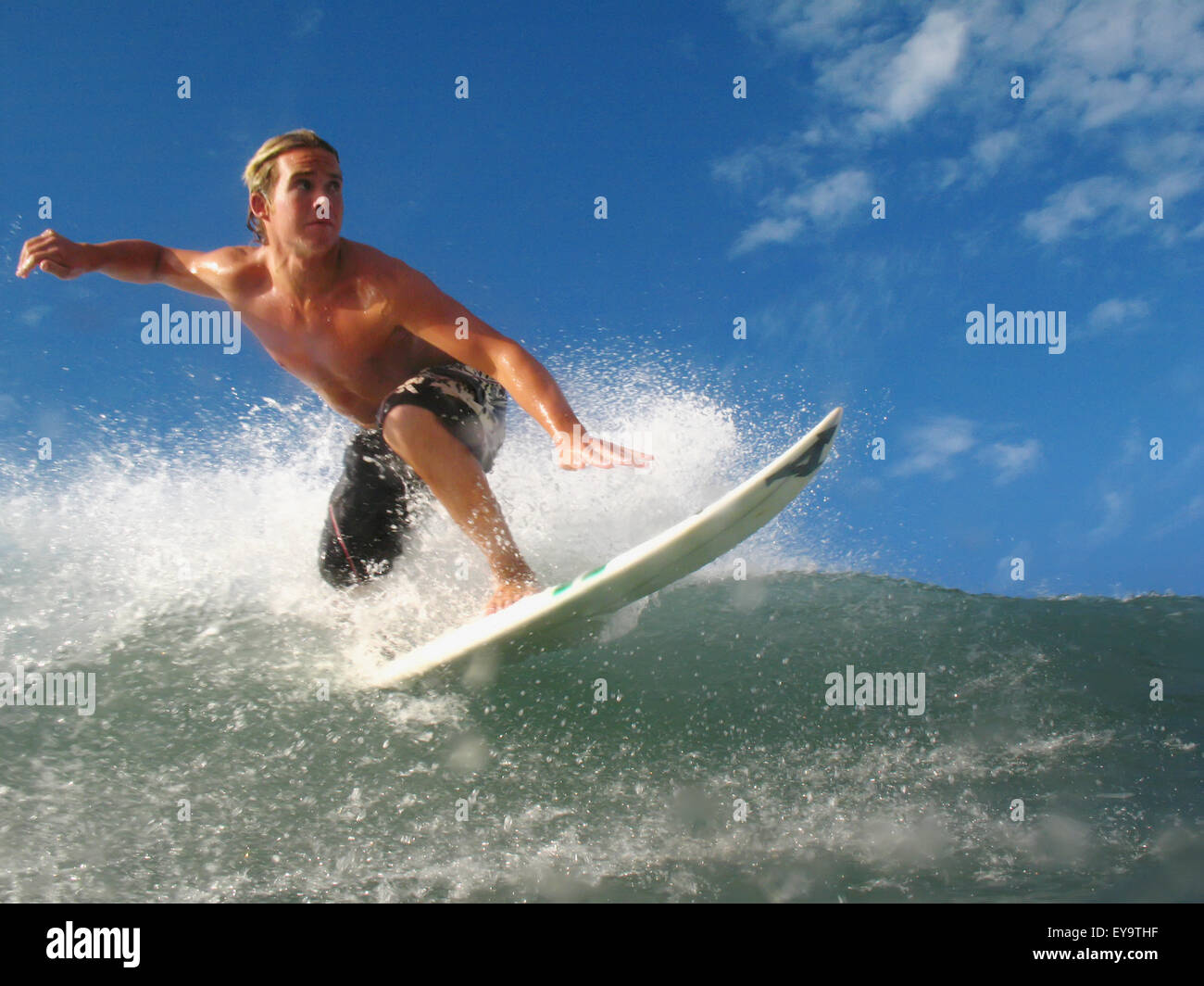 Blond Surfer On Crest Of A Wave, Low Angle View Stock Photo - Alamy