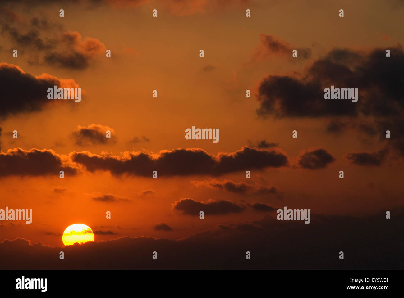 Sun And Clouds At Sunset In Orange Sky Stock Photo - Alamy