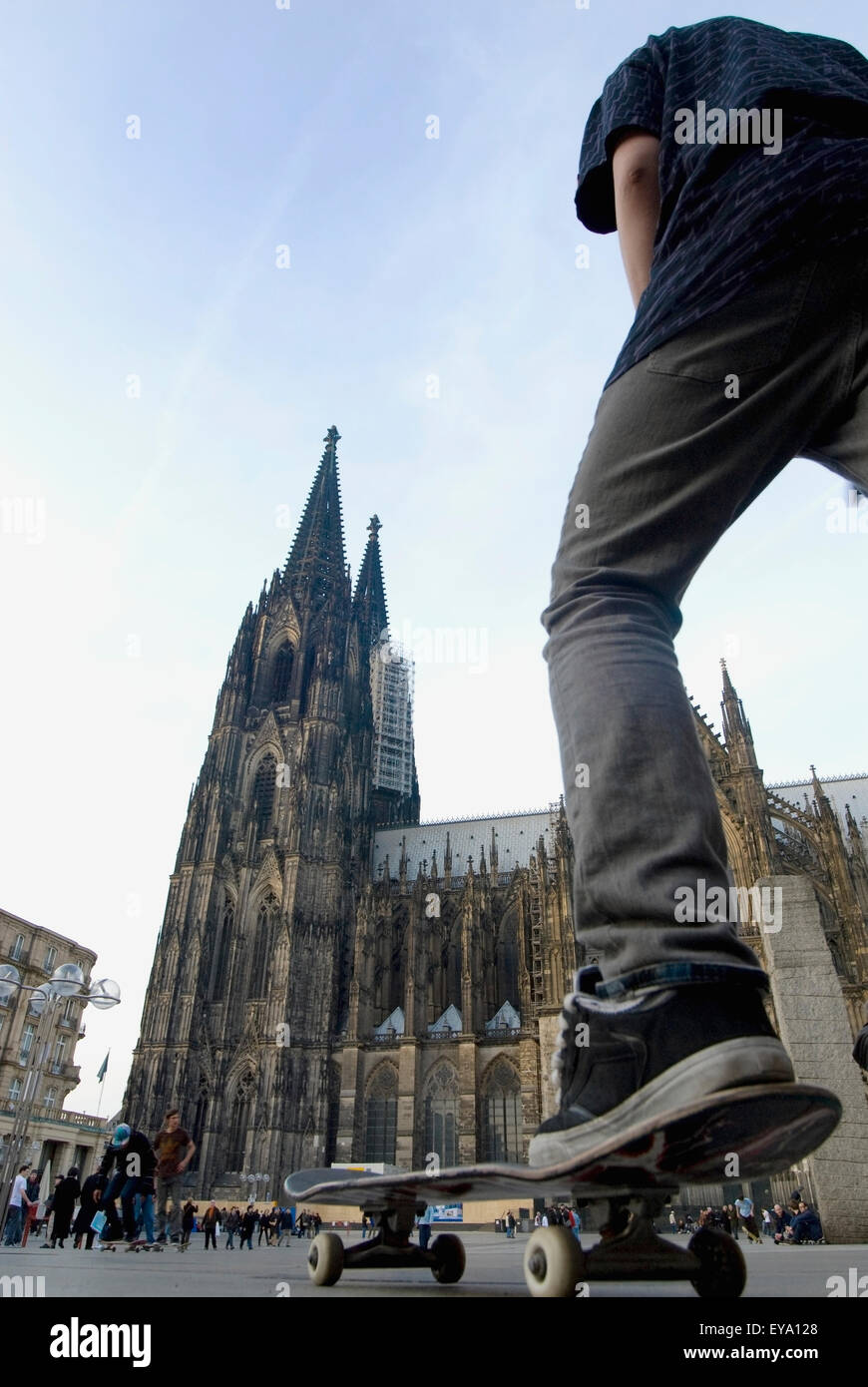 Man Skateboarding Near Cologne Cathedral (Kolner Dom),Low Angle View, Cologne,Germany Stock Photo