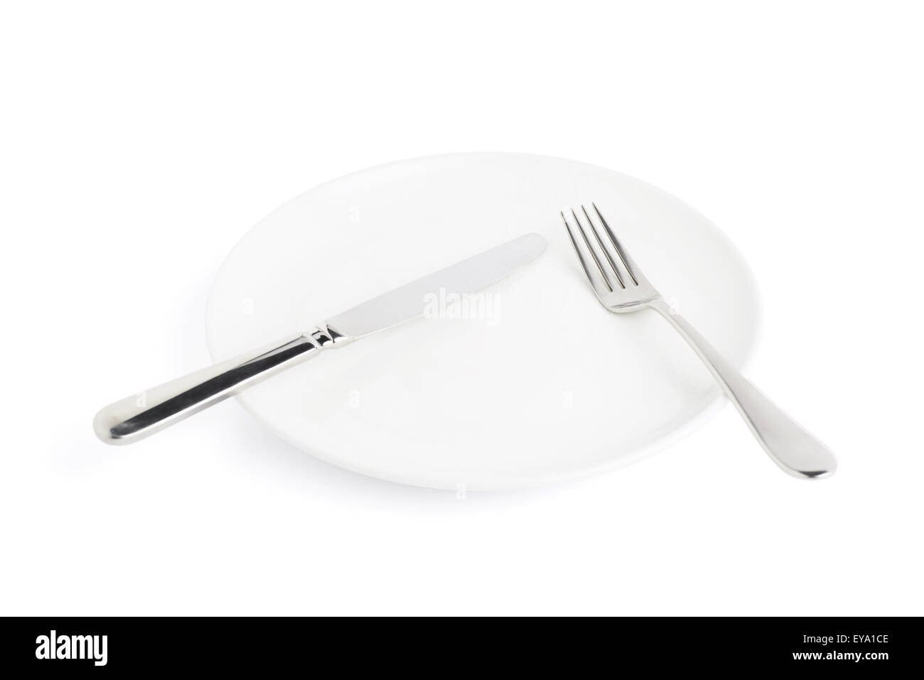 Knife and fork over the plate isolated Stock Photo Alamy
