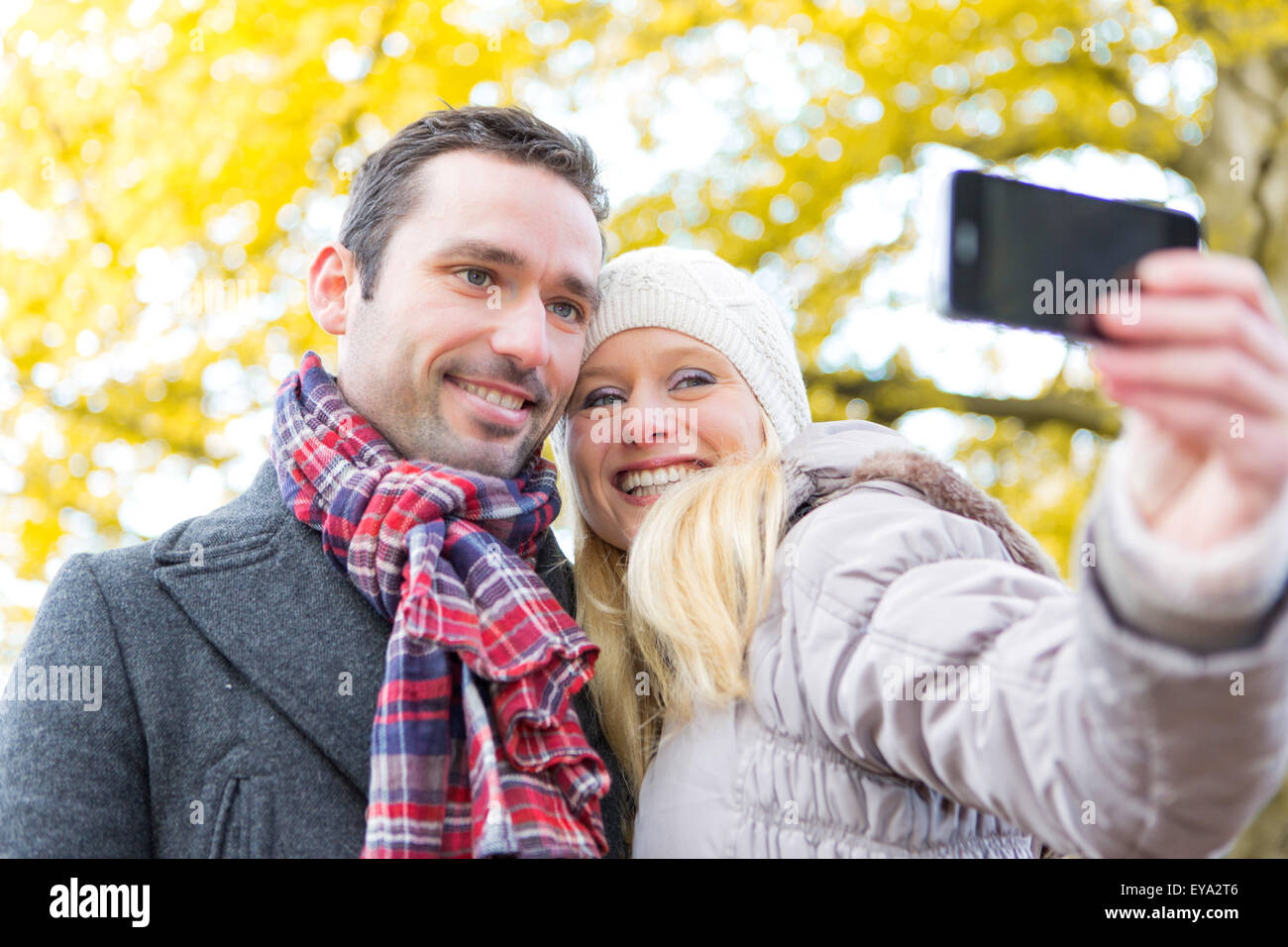 View of a Young attractive couple taking selfie in a parc Stock Photo ...