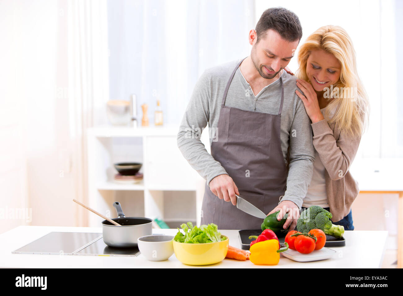 View of a Young attractive couple cooking in a kitchen Stock Photo