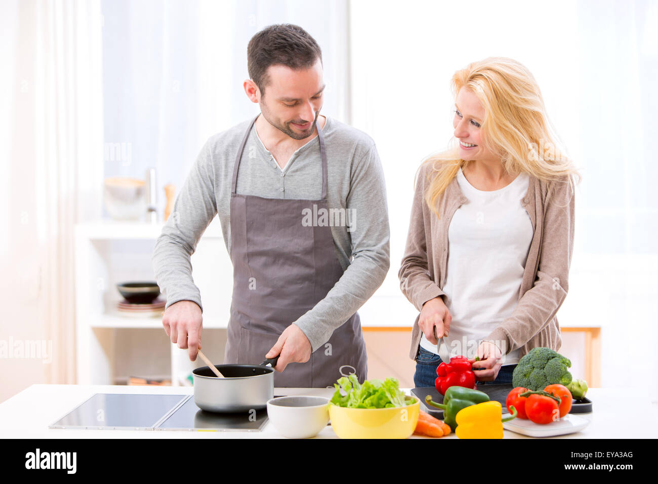 View of a Young attractive couple cooking in a kitchen Stock Photo