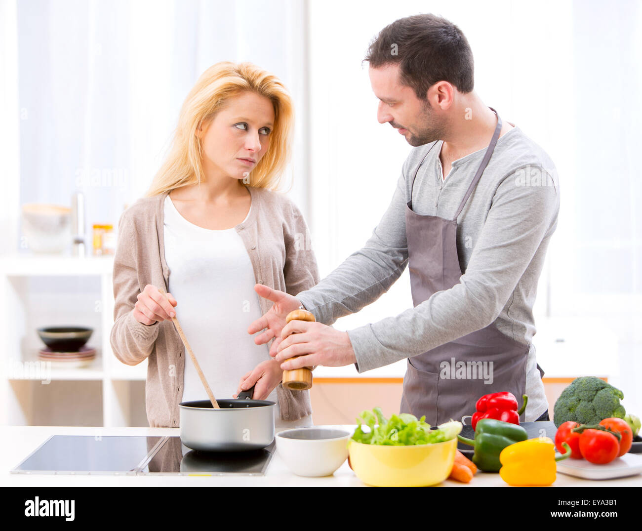 View of a Young attractive couple having an argue while cooking Stock Photo