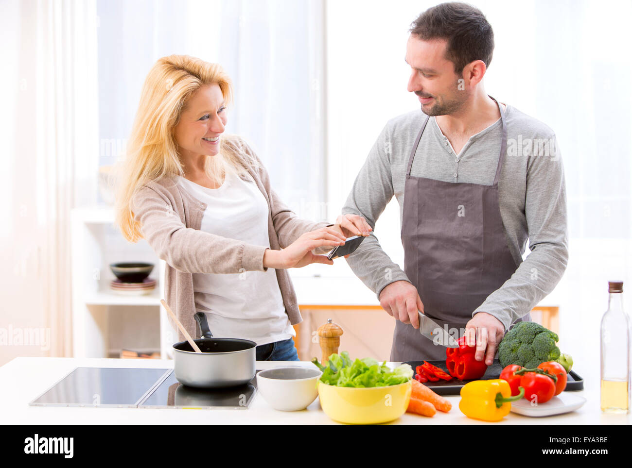 View of a Young attractive woman taking picture in kitchen Stock Photo