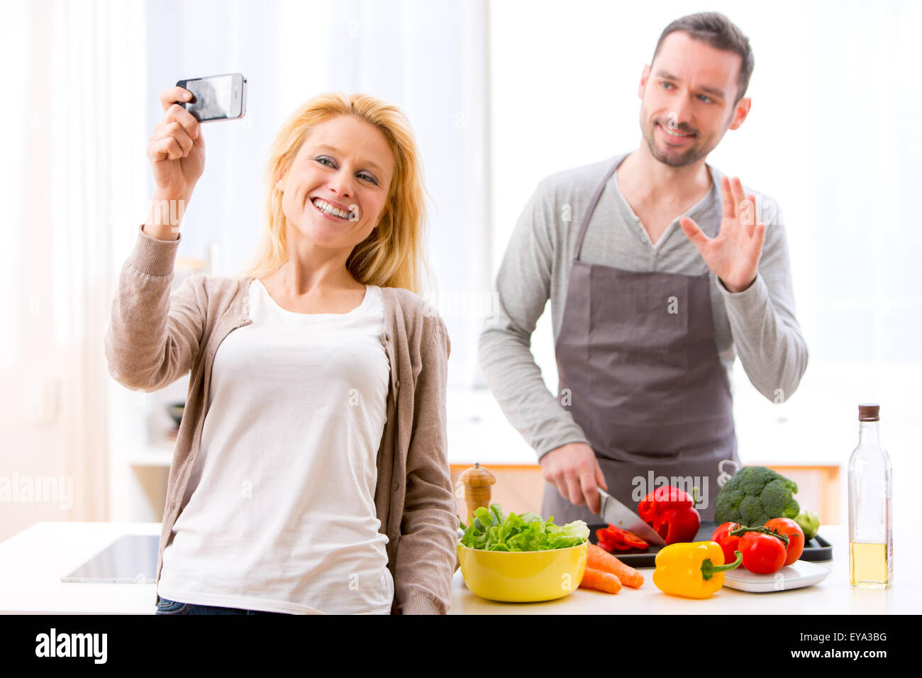 View of a Young attractive woman taking selfie in kitchen Stock Photo