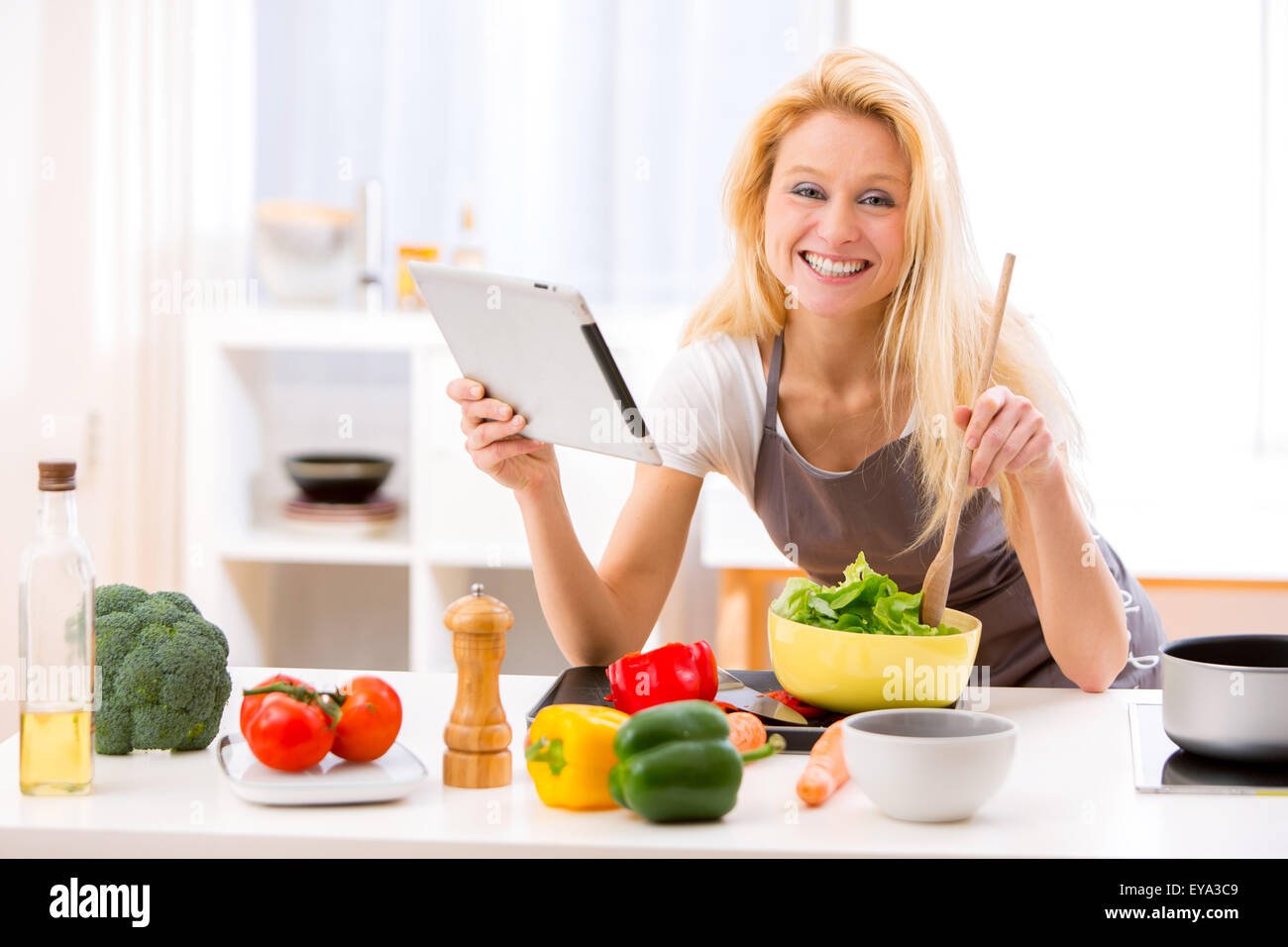 View of a Young attractive woman cooking in a kitchen Stock Photo