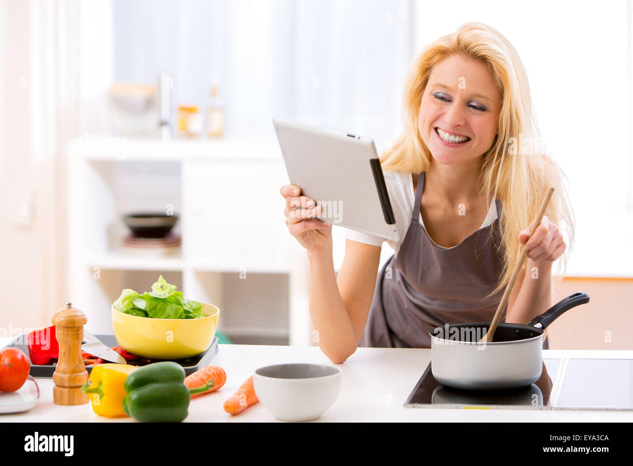 View of a Young attractive woman cooking in a kitchen Stock Photo