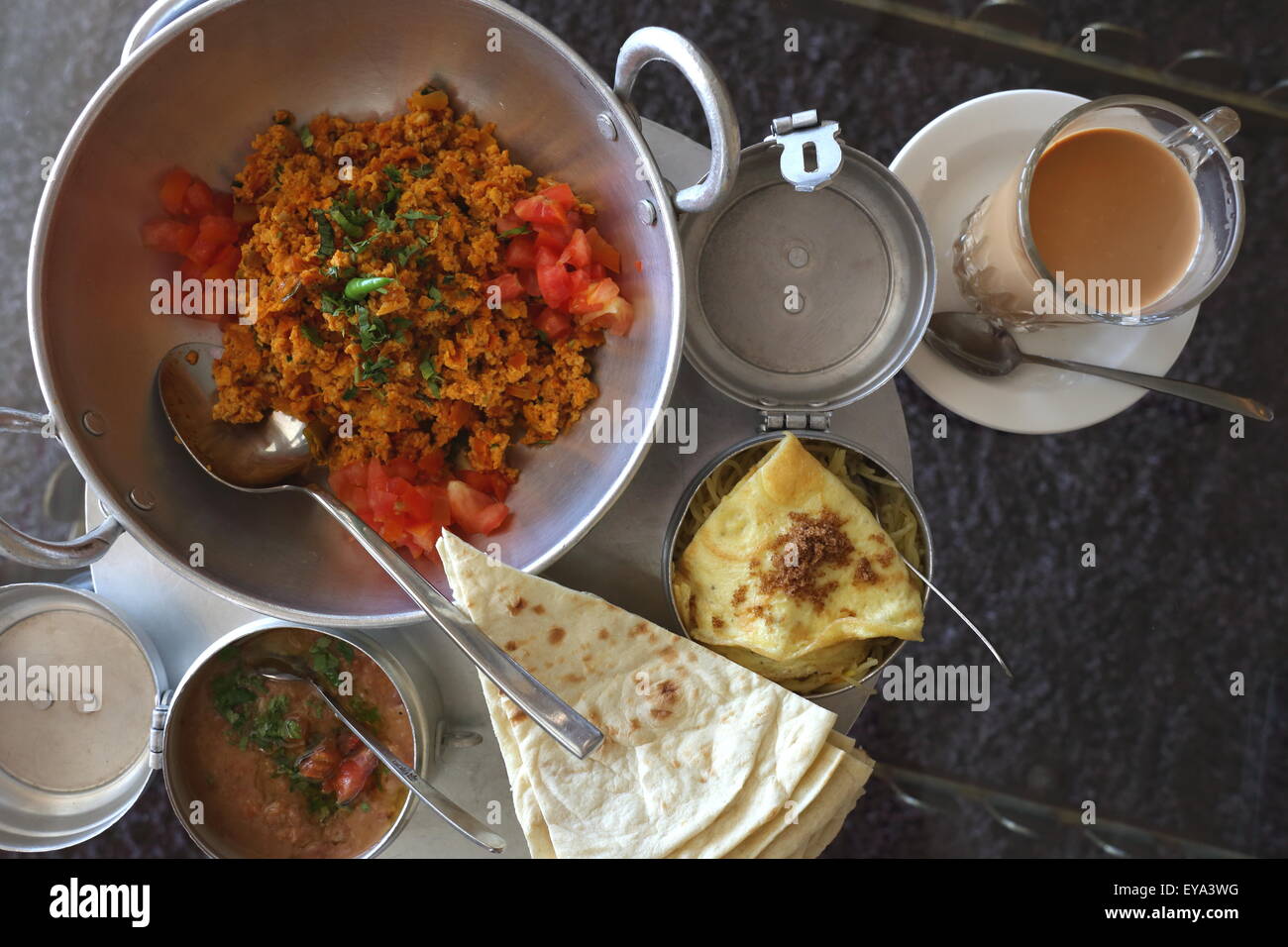 Bahrain breakfast of eggs, tomatoes chillies, beans tea and flat bread