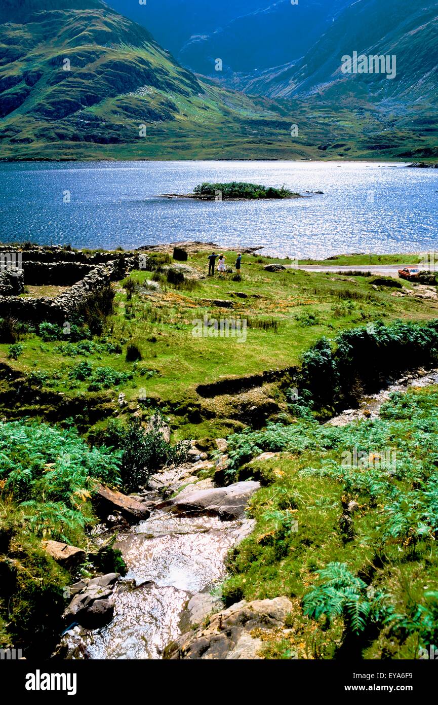 Doo Lough, Co Mayo, Ireland; Tourists By An Old Cottage Ruin Stock Photo